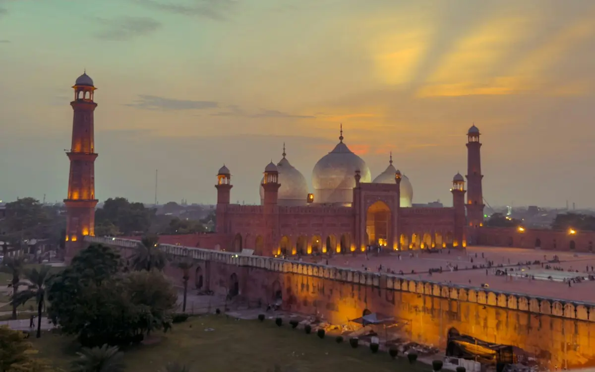 Religious Journeys Badshahi Mosque in Lahore at sunset with its minarets and domes